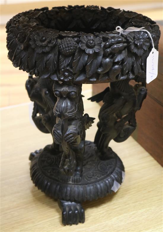 A carved jardiniere stand